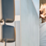 Professional work truck driver in his vehicle smiling at the camera, a couple in their RV happily looking at the road ahead. The Brandmotion compass logo is in the upper right hand side.