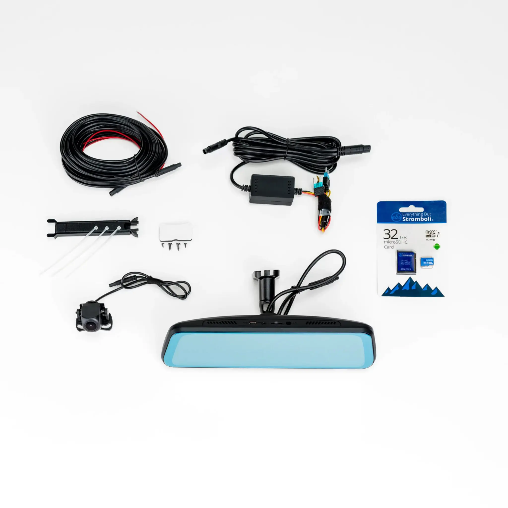Assorted car electronics cables and accessories laid out on a white surface, including a coiled power cable, connectors, mounting hardware, and a blue device at the bottom edge.